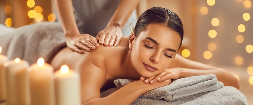 Relaxing spa massage with candles and warm lighting at The Zen Den, Glasgow.