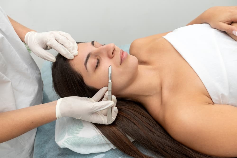 A client receiving an express dermaplaning treatment at The Zen Den to refresh the skin and reveal a smoother, brighter complexion.