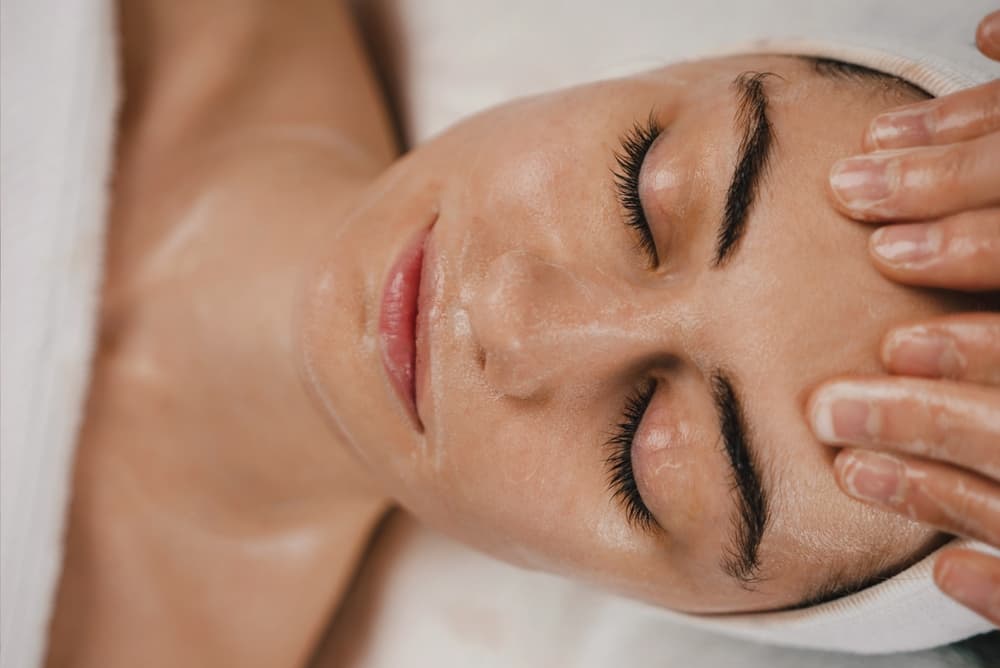 Client enjoying a rejuvenating facial massage at The Zen Den, with gentle techniques to relax muscles, improve circulation, and promote glowing skin.