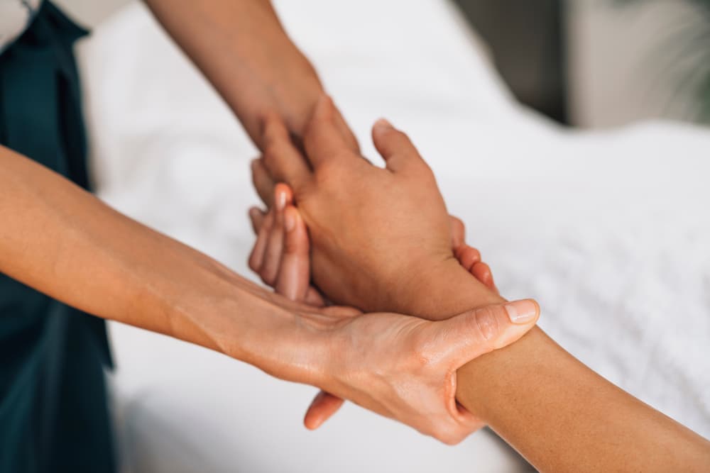 Close-up of a soothing hand and arm massage at The Zen Den, easing tension and promoting relaxation through gentle, skilled movements.