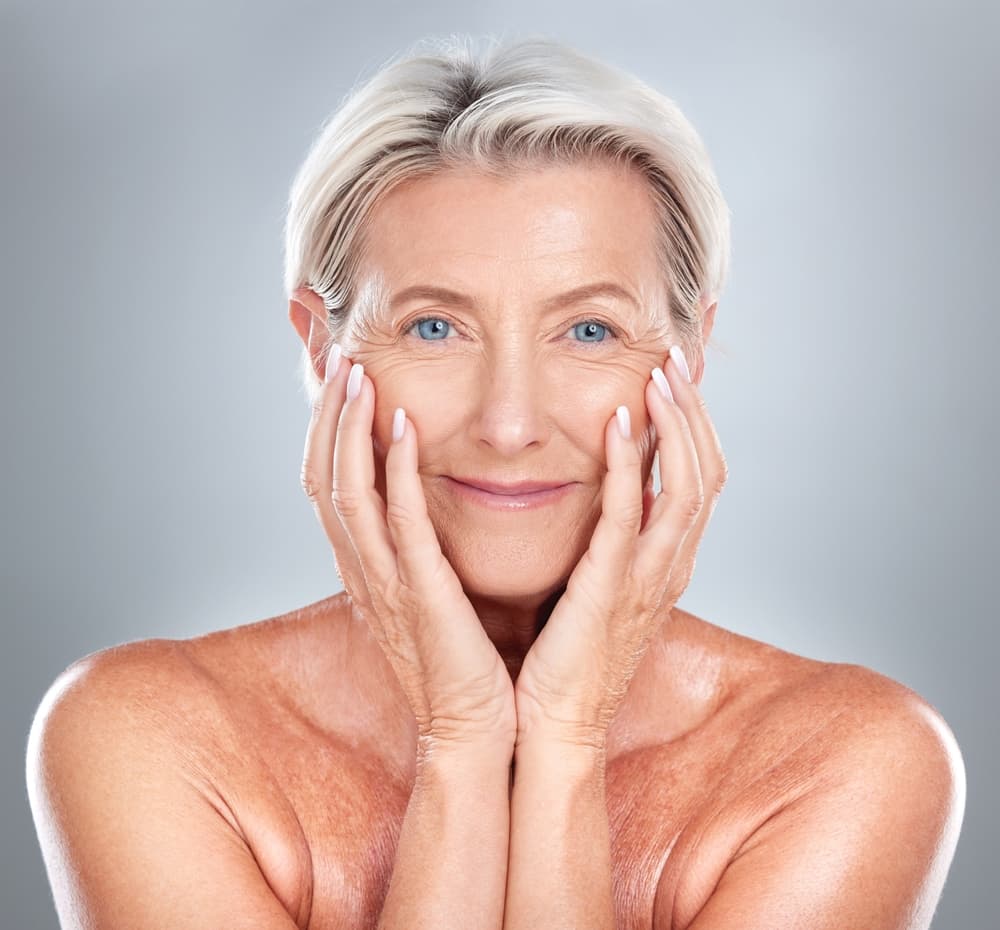 A mature woman with bright, healthy skin after the Hydradermie Youth Age Logic facial at The Zen Den, targeting signs of ageing for visibly firmer skin.