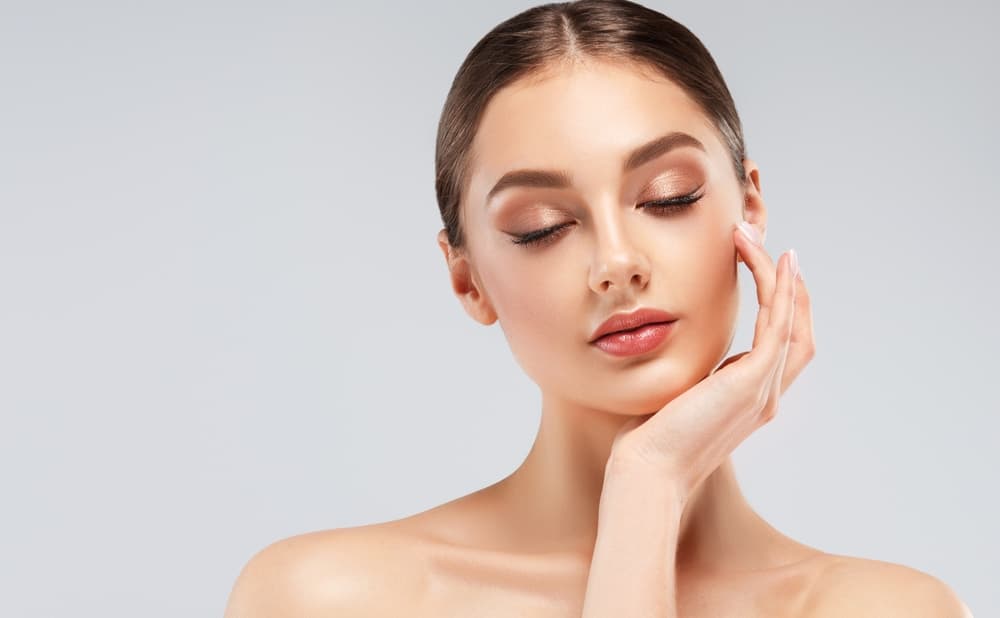 A woman with smooth, radiant skin after a HydrO2 Clear Skin Express facial at The Zen Den, a quick treatment to refresh and decongest.