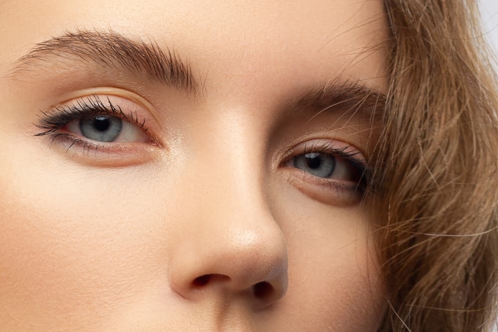Close-up of perfectly shaped and lifted eyebrows after a laminated brows treatment at The Zen Den, highlighting the natural texture and definition.