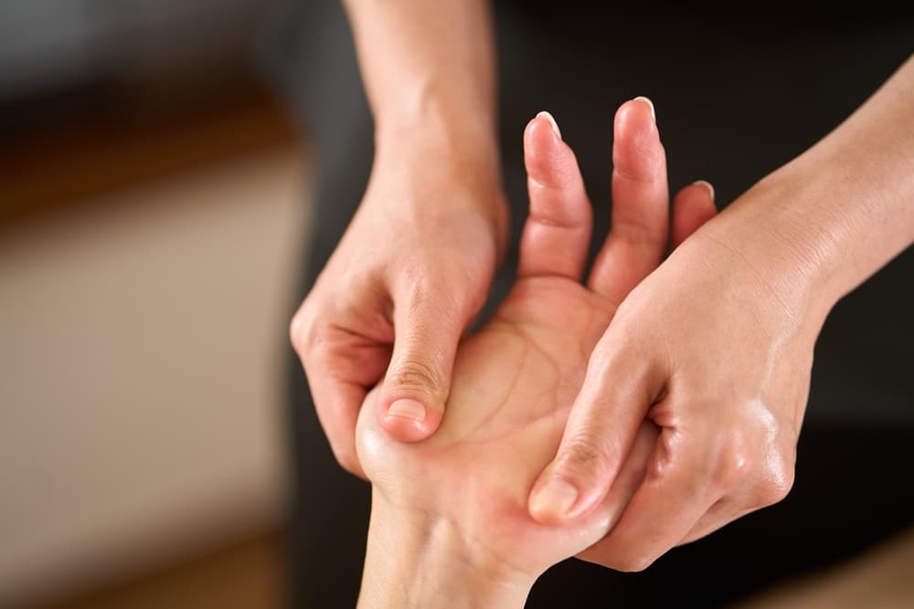 Close-up of a soothing mini hand massage at The Zen Den, with gentle pressure applied to relax muscles and relieve tension.