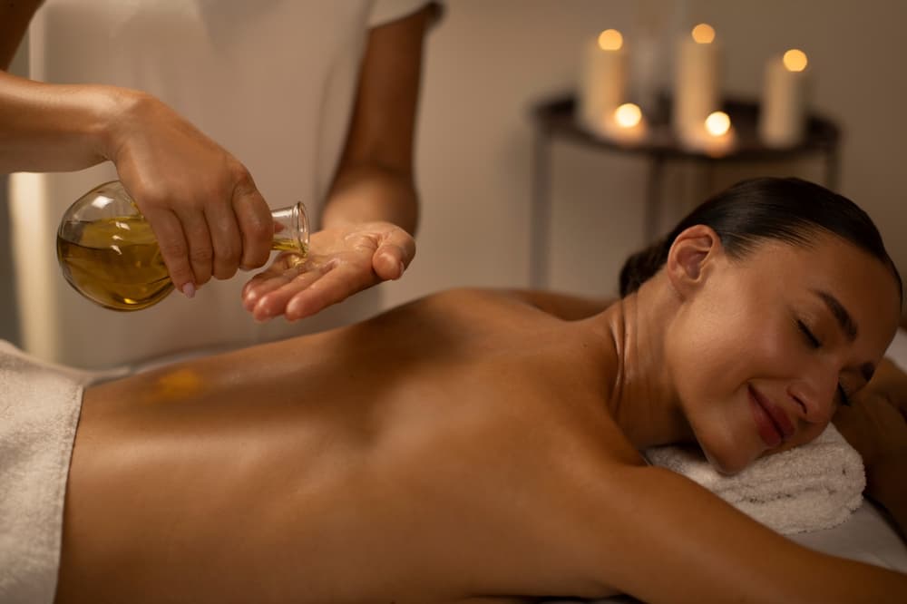 Wellbeing back massage at The Zen Den, using warm oils and gentle techniques to relieve tension and promote deep relaxation.