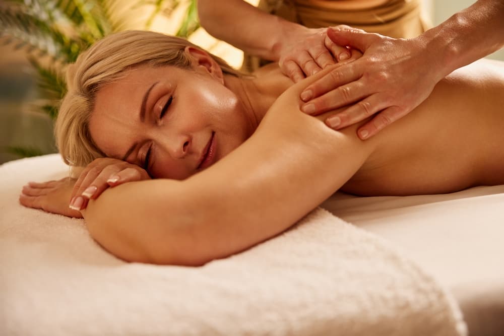 A woman enjoying a relaxing shoulder and back massage at The Zen Den @ Watt A Beauty.
